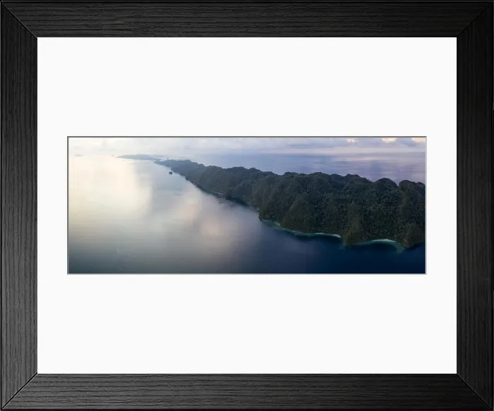 Framed Print : Seen from above, remote islands are surrounded by coral reefs in Raja Ampat, Indonesia. This region is known as the heart of the Coral Triangle Framed Print : Seen from above, remote islands are surrounded by coral reefs in Raja Ampat, Indonesia. This region is known as the heart of the Coral Triangle