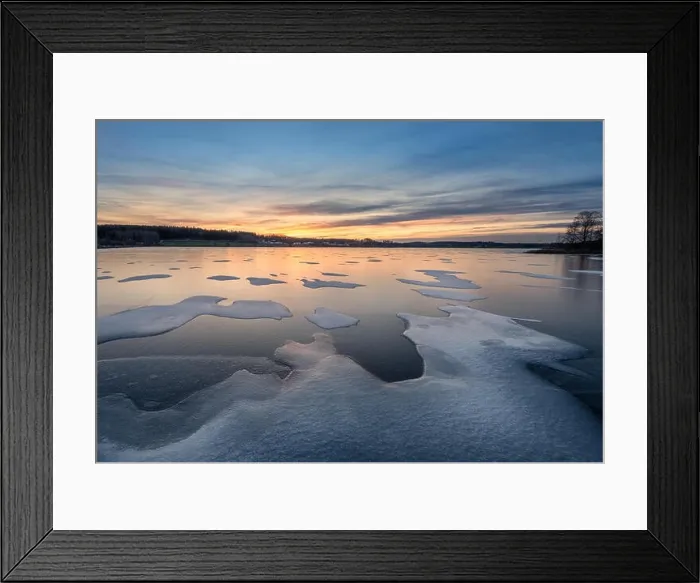 Framed Print : Scenic winter landscape with frozen lake, sunset and beautiful evening light in Finland Framed Print : Scenic winter landscape with frozen lake, sunset and beautiful evening light in Finland