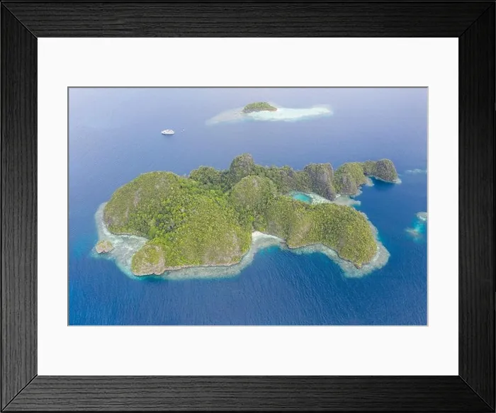 Framed Print : Warm seas surround rugged limestone islands in Raja Ampat, Indonesia. This area is known as the Coral Triangle due to its high marine biodiversity Framed Print : Warm seas surround rugged limestone islands in Raja Ampat, Indonesia. This area is known as the Coral Triangle due to its high marine biodiversity