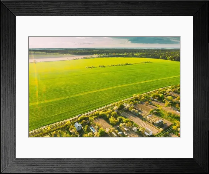 Framed Print : Countryside Rural Landscape With Small Village, Gardens And Green Field In Spring Summer Day. Elevated View Framed Print : Countryside Rural Landscape With Small Village, Gardens And Green Field In Spring Summer Day. Elevated View