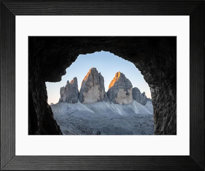Framed Print : Tre Cime Di Lavaredo peaks in incredible orange sunset light. View from the cave in mountain against Three peaks of Lavaredo, Dolomite Alps, Italy Framed Print : Tre Cime Di Lavaredo peaks in incredible orange sunset light. View from the cave in mountain against Three peaks of Lavaredo, Dolomite Alps, Italy