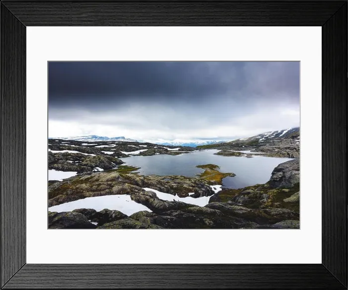 Framed Print : Typical norwegian landscape with snowy mountains and clear lake near the Trolltunga rock - most spectacular and famous scenic cliff in Norway Framed Print : Typical norwegian landscape with snowy mountains and clear lake near the Trolltunga rock - most spectacular and famous scenic cliff in Norway