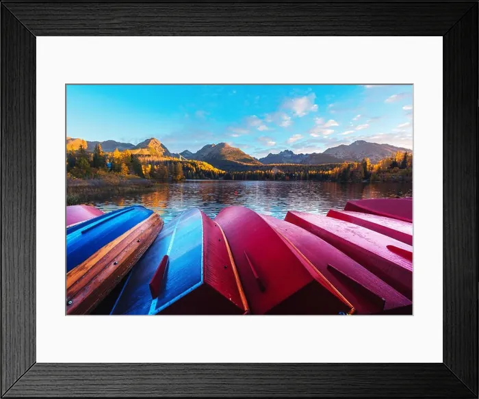 Framed Print : Picturesque autumn view of lake Strbske pleso in High Tatras National Park, Slovakia. Row of red wooden boats and high mountains on background