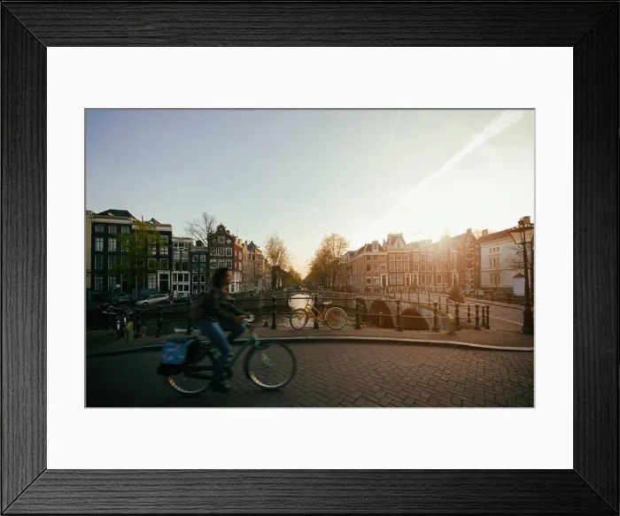 Framed Print : Amsterdam people riding bicycles in historical part in Amsterdam, Netherlands Framed Print : Amsterdam people riding bicycles in historical part in Amsterdam, Netherlands