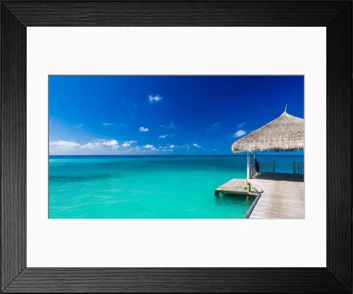 Framed Print : Exotic paradise banner, water bungalow, villa. Travel, tourism vacations concept. Tropical resort and infinity blue seascape, ocean water, Maldives Framed Print : Exotic paradise banner, water bungalow, villa. Travel, tourism vacations concept. Tropical resort and infinity blue seascape, ocean water, Maldives