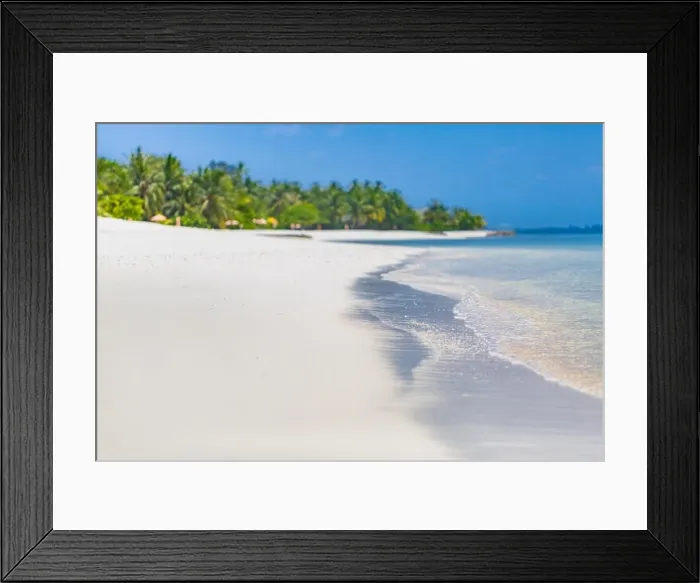 Framed Print : Tropical scenery view on blue lagoon beach with perfect white sand, palm trees, palm tree blur in foreground, beach scene Framed Print : Tropical scenery view on blue lagoon beach with perfect white sand, palm trees, palm tree blur in foreground, beach scene