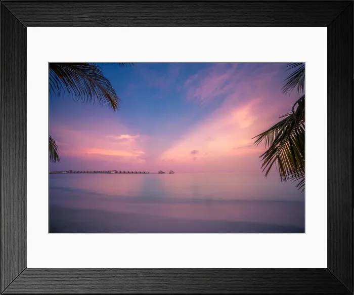 Framed Print : Sunset on Maldives island, luxury water villas resort. Beautiful sky and clouds and palm leaves beach background for summer vacation holiday Framed Print : Sunset on Maldives island, luxury water villas resort. Beautiful sky and clouds and palm leaves beach background for summer vacation holiday