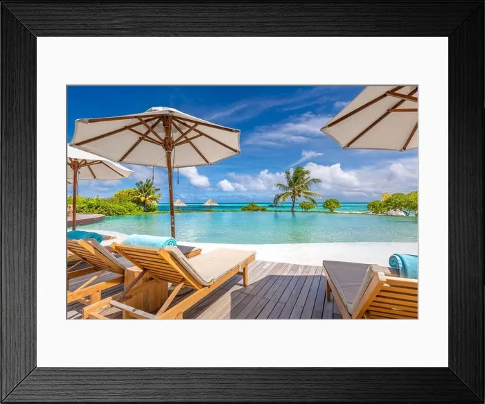 Framed Print : Summer tourism landscape. Luxurious beach resort with swimming pool and beach chairs or loungers under umbrellas infinity pool palm trees, blue sky