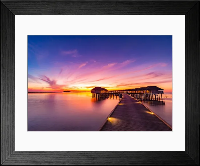 Framed Print : Sunset on Maldives island, luxury water villas resort and wooden pier. Beautiful sky and clouds and beach background for summer vacation holiday Framed Print : Sunset on Maldives island, luxury water villas resort and wooden pier. Beautiful sky and clouds and beach background for summer vacation holiday