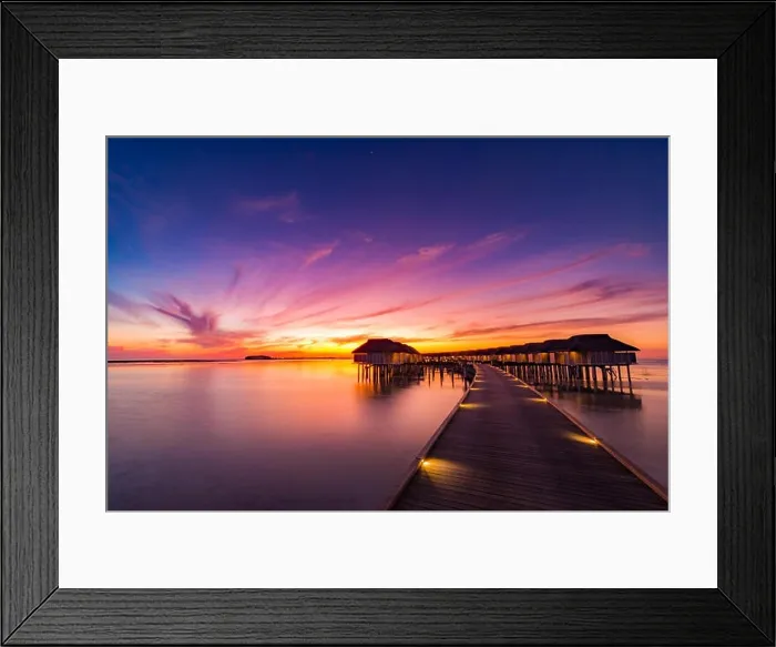 Framed Print : Sunset on Maldives island, luxury water villas resort and wooden pier. Beautiful sky and clouds and beach background for summer vacation holiday Framed Print : Sunset on Maldives island, luxury water villas resort and wooden pier. Beautiful sky and clouds and beach background for summer vacation holiday