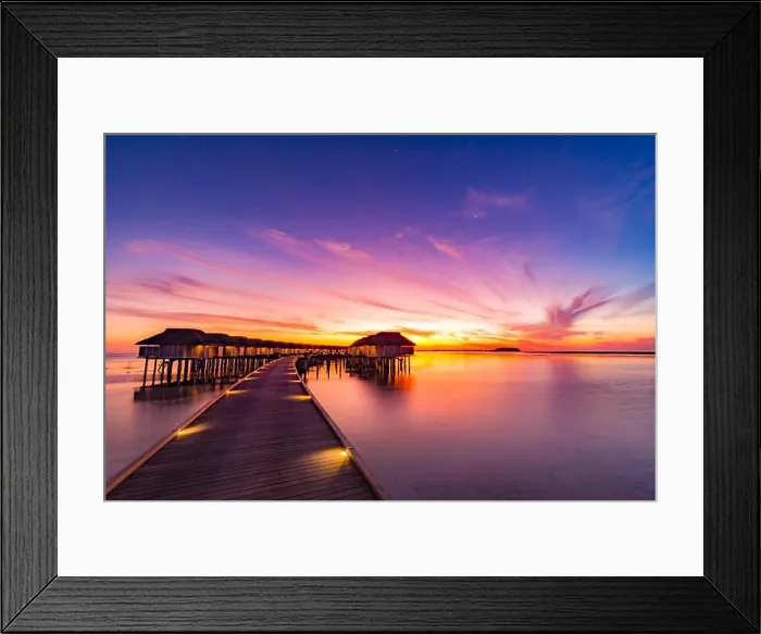 Framed Print : Sunset on Maldives island, luxury water villas resort and wooden pier. Beautiful sky and clouds and beach background for summer vacation holiday Framed Print : Sunset on Maldives island, luxury water villas resort and wooden pier. Beautiful sky and clouds and beach background for summer vacation holiday
