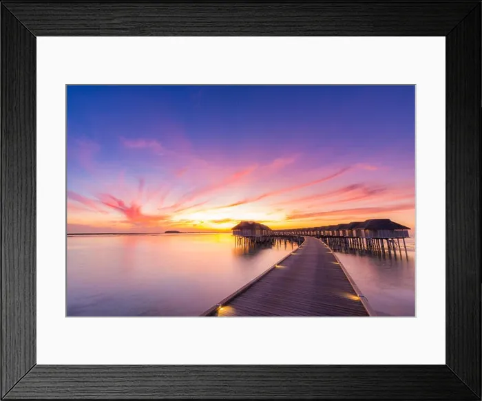 Framed Print : Sunset on Maldives island, luxury water villas resort and wooden pier. Beautiful sky and clouds and beach background for summer vacation holiday Framed Print : Sunset on Maldives island, luxury water villas resort and wooden pier. Beautiful sky and clouds and beach background for summer vacation holiday