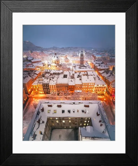 Framed Print : Gorgeus cityscape of winter Lviv city glowing by city lights with roofs covered by snow from top of town hall, Ukraine, Europe. Landscape photography Framed Print : Gorgeus cityscape of winter Lviv city glowing by city lights with roofs covered by snow from top of town hall, Ukraine, Europe. Landscape photography