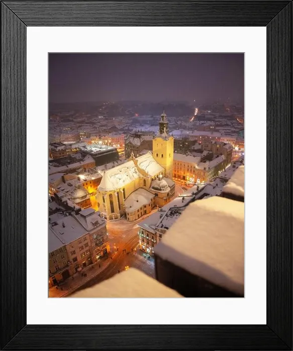 Framed Print : Gorgeus cityscape of winter Lviv city with roofs covered by snow from top of town hall, Ukraine, Europe. Latin Cathedral glowing by city lights Framed Print : Gorgeus cityscape of winter Lviv city with roofs covered by snow from top of town hall, Ukraine, Europe. Latin Cathedral glowing by city lights