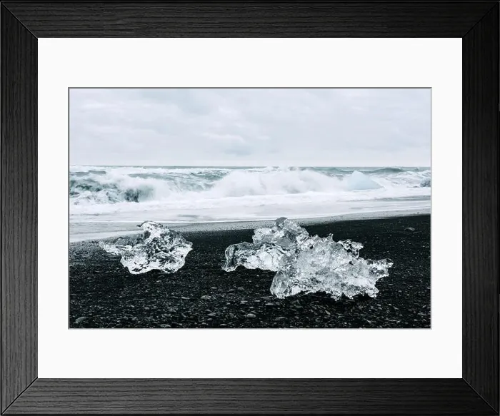 Framed Print : Iceberg pieces on black Diamond beach near Jokulsarlon lagoon, Iceland. Atlantic ocean waves and cloudy sky on background. Landscape photography Framed Print : Iceberg pieces on black Diamond beach near Jokulsarlon lagoon, Iceland. Atlantic ocean waves and cloudy sky on background. Landscape photography
