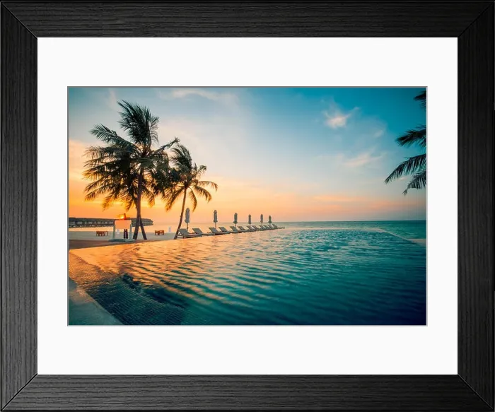 Framed Print : Tranquil infinity swimming pool in sunset sunrise with palm trees and deck chairs and wooden loungers Framed Print : Tranquil infinity swimming pool in sunset sunrise with palm trees and deck chairs and wooden loungers