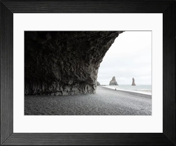 Framed Print : Incredible view on Black beach and Troll toes cliffs in cloudy weather. Lonely tourist with tripod going on coastline. Reynisdrangar, Vik, Iceland Framed Print : Incredible view on Black beach and Troll toes cliffs in cloudy weather. Lonely tourist with tripod going on coastline. Reynisdrangar, Vik, Iceland