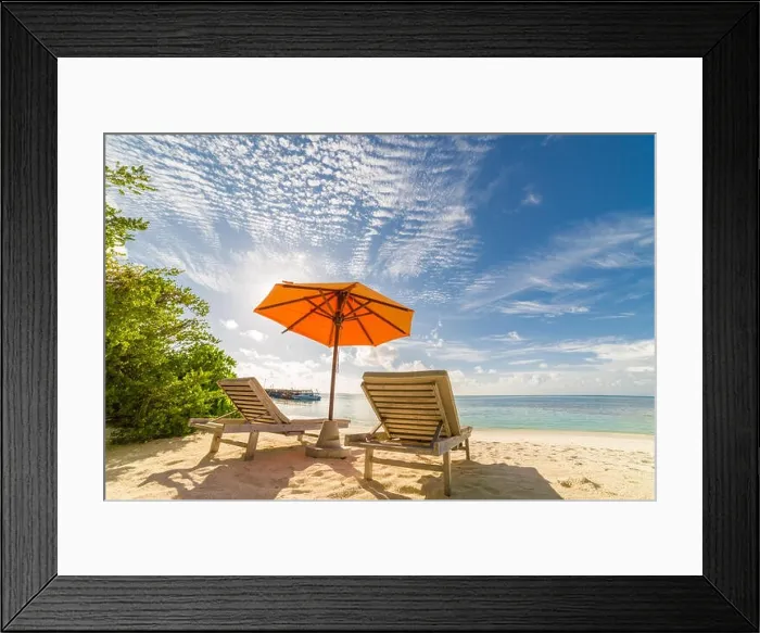Framed Print : Two lounges or sun beds with umbrella on sunny beach. Summer landscape with sea view and mangrove. Tropical island Framed Print : Two lounges or sun beds with umbrella on sunny beach. Summer landscape with sea view and mangrove. Tropical island