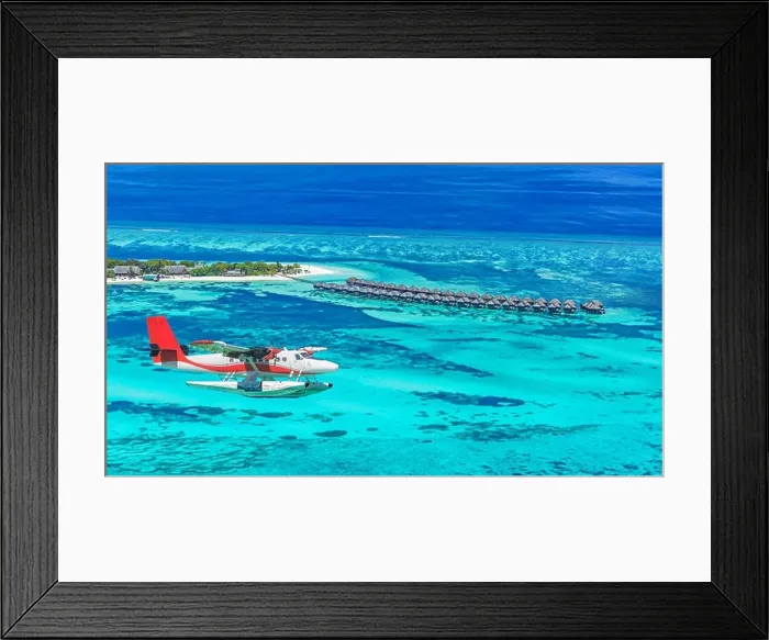 Framed Print : Aerial view of a seaplane approaching island in the Maldives. Maldives beach from birds eye view. Aerial view on Maldives island, atolls and blue sea Framed Print : Aerial view of a seaplane approaching island in the Maldives. Maldives beach from birds eye view. Aerial view on Maldives island, atolls and blue sea