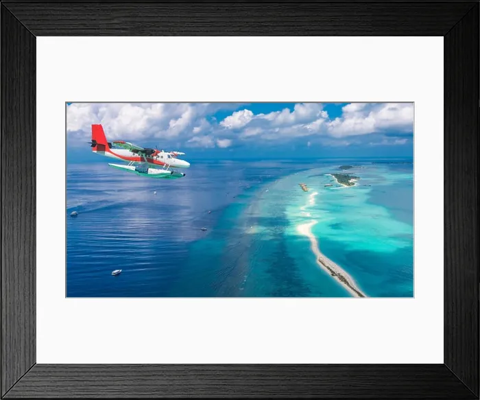 Framed Print : Aerial view of a seaplane approaching island in the Maldives. Maldives beach from birds eye view. Aerial view on Maldives island, atolls and blue sea Framed Print : Aerial view of a seaplane approaching island in the Maldives. Maldives beach from birds eye view. Aerial view on Maldives island, atolls and blue sea