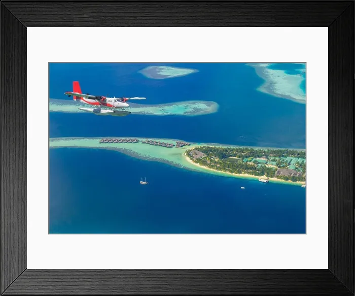 Framed Print : Aerial view of a seaplane approaching island in the Maldives. Maldives beach from birds eye view. Aerial view on Maldives island, atolls and blue sea Framed Print : Aerial view of a seaplane approaching island in the Maldives. Maldives beach from birds eye view. Aerial view on Maldives island, atolls and blue sea