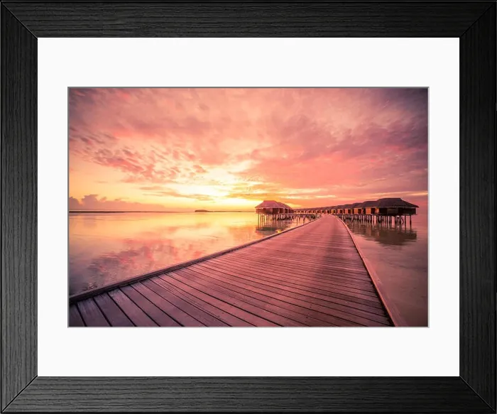 Framed Print : Sunset on Maldives island, luxury water villas resort and wooden pier. Beautiful sky and clouds and beach background for summer vacation holiday