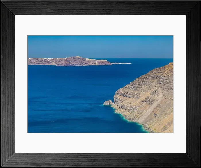 Framed Print : Cliff wall of Santorini island, Greece. Clear blue ocean, sea, with copy space, place for text. Shore, coast of dry rocks Framed Print : Cliff wall of Santorini island, Greece. Clear blue ocean, sea, with copy space, place for text. Shore, coast of dry rocks