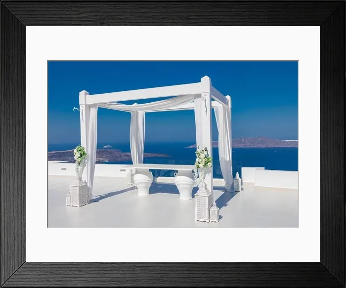 Framed Print : Santorini Island, Greece. Wedding decoration on a popular couple destination. Elegant wedding arch with white flowers, vases on background of blue sea Framed Print : Santorini Island, Greece. Wedding decoration on a popular couple destination. Elegant wedding arch with white flowers, vases on background of blue sea