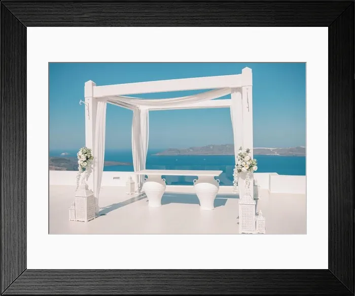 Framed Print : Santorini Island, Greece. Wedding decoration on a popular couple destination. Elegant wedding arch with white flowers, vases on background of blue sea Framed Print : Santorini Island, Greece. Wedding decoration on a popular couple destination. Elegant wedding arch with white flowers, vases on background of blue sea