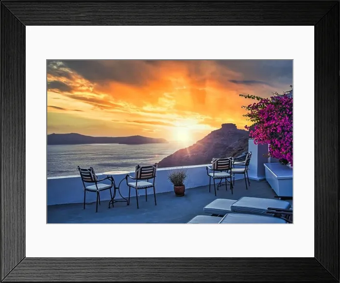Framed Print : Santorini island sunset. Caldera view with chairs and flowers, romantic mood, couple travel vacation landscape destination scenic. Tourism romance Framed Print : Santorini island sunset. Caldera view with chairs and flowers, romantic mood, couple travel vacation landscape destination scenic. Tourism romance