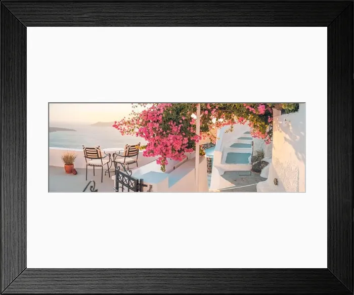 Framed Print : Santorini island sunset. Caldera view with chairs and flowers, romantic mood, couple travel vacation landscape destination scenic. Tourism romance Framed Print : Santorini island sunset. Caldera view with chairs and flowers, romantic mood, couple travel vacation landscape destination scenic. Tourism romance