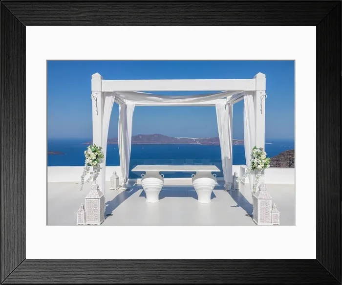 Framed Print : Santorini Island, Greece. Wedding decoration on a popular couple destination. Elegant wedding arch with white flowers, vases on background of blue sea Framed Print : Santorini Island, Greece. Wedding decoration on a popular couple destination. Elegant wedding arch with white flowers, vases on background of blue sea