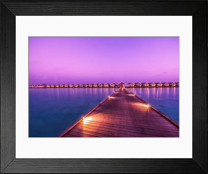 Framed Print : Sunset on Maldives island, luxury water villas resort and wooden pier. Beautiful sky and clouds and beach background for summer vacation holiday Framed Print : Sunset on Maldives island, luxury water villas resort and wooden pier. Beautiful sky and clouds and beach background for summer vacation holiday