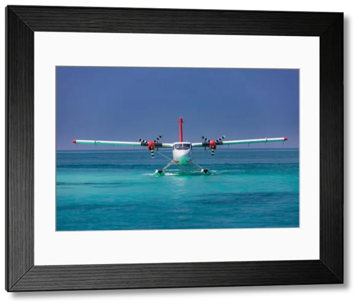Framed Print : Exotic scene with seaplane on Maldives sea landing. Vacation or holiday in Maldives concept background Framed Print : Exotic scene with seaplane on Maldives sea landing. Vacation or holiday in Maldives concept background