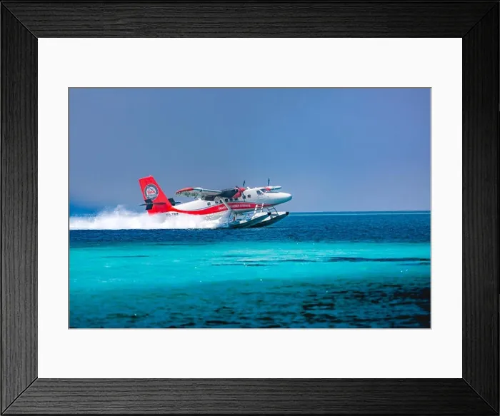 Framed Print : Red and white seaplane approaching island in the Maldives. Transmaldivian airlines in Maldives island Framed Print : Red and white seaplane approaching island in the Maldives. Transmaldivian airlines in Maldives island