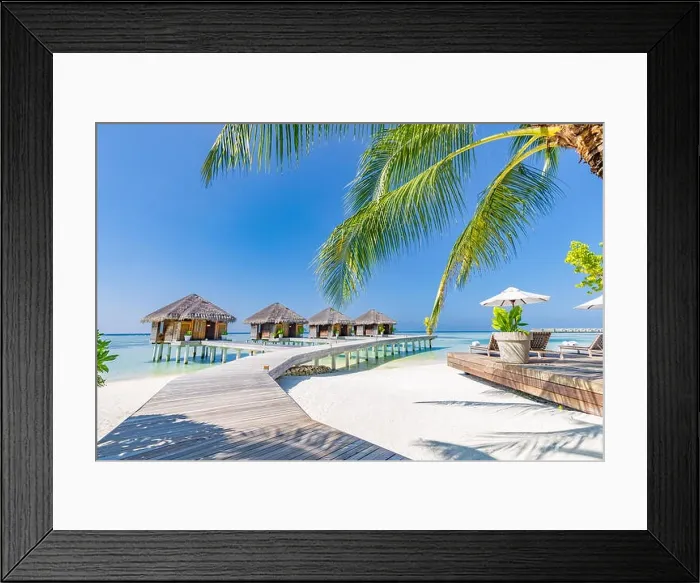 Framed Print : Tropical beach in Maldives with palm trees and blue lagoon, wooden jetty. Luxury vacation and holiday background, loungers, beach chairs and umbrella Framed Print : Tropical beach in Maldives with palm trees and blue lagoon, wooden jetty. Luxury vacation and holiday background, loungers, beach chairs and umbrella