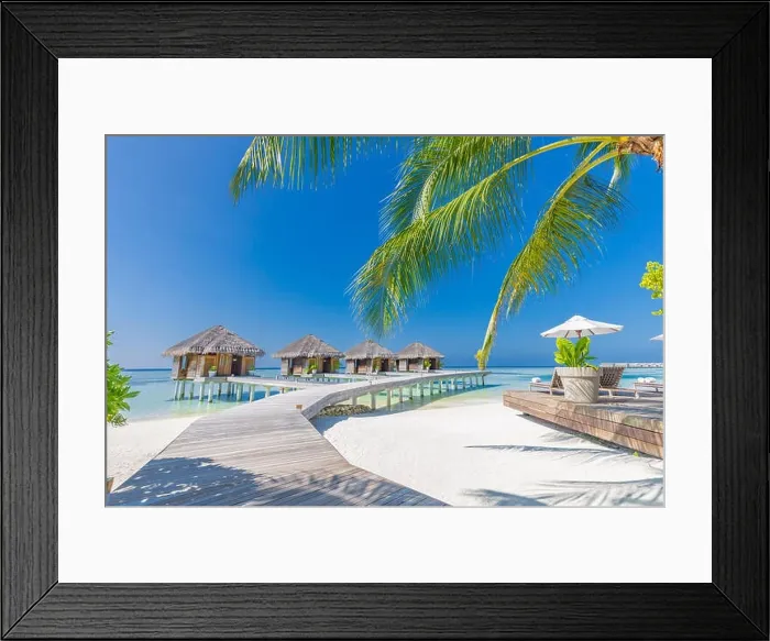 Framed Print : Tropical beach in Maldives with palm trees and blue lagoon, wooden jetty. Luxury vacation and holiday background, loungers, beach chairs and umbrella Framed Print : Tropical beach in Maldives with palm trees and blue lagoon, wooden jetty. Luxury vacation and holiday background, loungers, beach chairs and umbrella