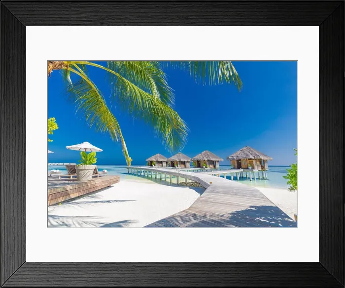 Framed Print : Tropical beach in Maldives with palm trees and blue lagoon, wooden jetty. Luxury vacation and holiday background, loungers, beach chairs and umbrella Framed Print : Tropical beach in Maldives with palm trees and blue lagoon, wooden jetty. Luxury vacation and holiday background, loungers, beach chairs and umbrella