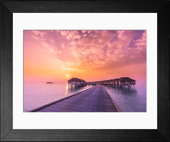 Framed Print : Sunset on Maldives island, luxury water villas resort and wooden pier. Beautiful sky and clouds and beach background for summer vacation holiday