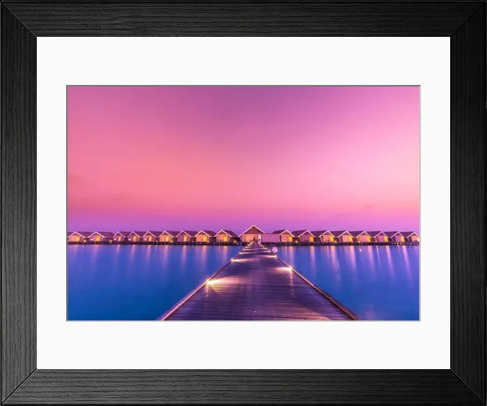 Framed Print : Sunset on Maldives island, luxury water villas resort and wooden pier. Beautiful sky and clouds and beach background for summer vacation holiday Framed Print : Sunset on Maldives island, luxury water villas resort and wooden pier. Beautiful sky and clouds and beach background for summer vacation holiday