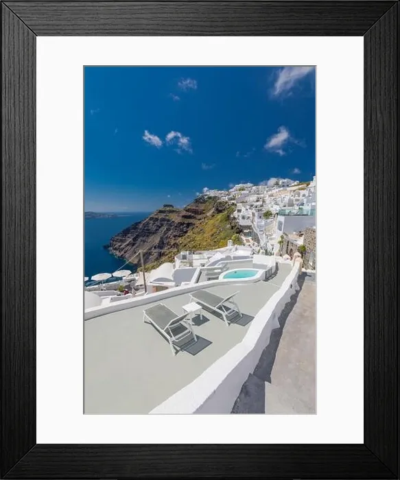 Framed Print : Beach bed chair with towel looking out over the caldera by the swimming pool, Santorini Oia. Luxury chaise lounge, amazing travel destination, summer Framed Print : Beach bed chair with towel looking out over the caldera by the swimming pool, Santorini Oia. Luxury chaise lounge, amazing travel destination, summer