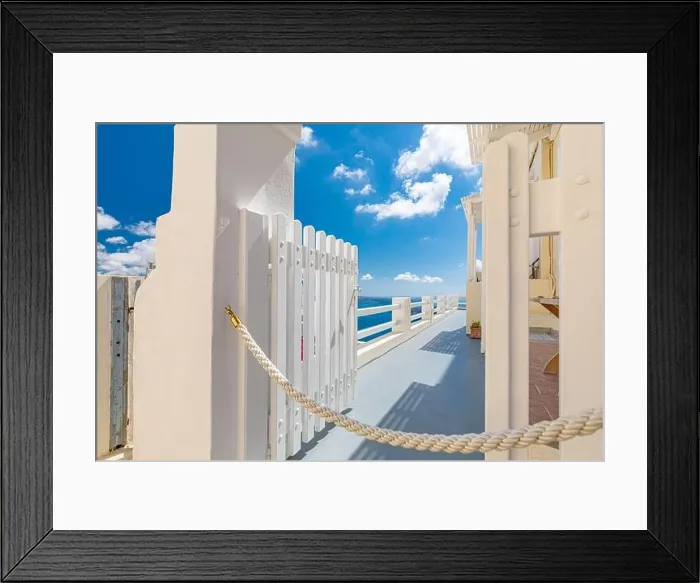 Framed Print : Blue sky with white gate and beautiful sea view. Amazing caldera with white architecture. Luxury summer travel and romantic vacation destination mood Framed Print : Blue sky with white gate and beautiful sea view. Amazing caldera with white architecture. Luxury summer travel and romantic vacation destination mood