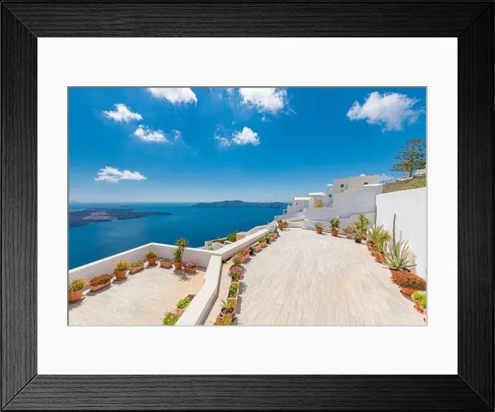 Framed Print : Beautiful terrace in Santorini with breathtaking view. Flowers pots with picturesque view of traditional cycladic Santorini houses Framed Print : Beautiful terrace in Santorini with breathtaking view. Flowers pots with picturesque view of traditional cycladic Santorini houses