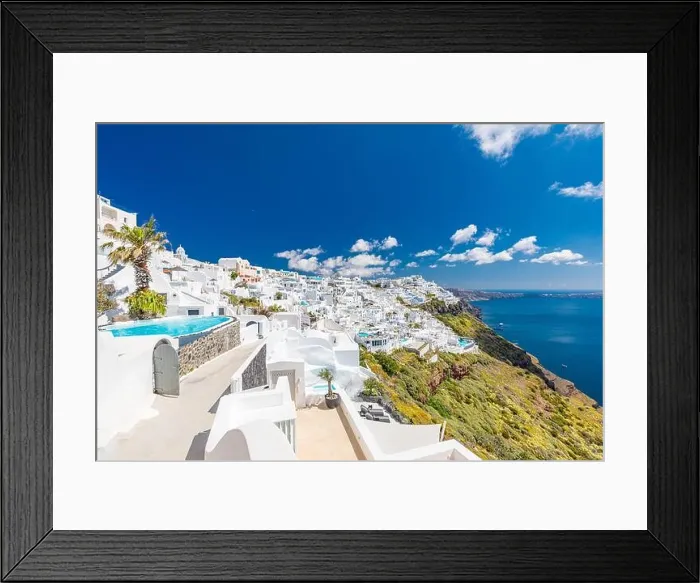 Framed Print : Beautiful white caldera view of Santorini in Greece. Luxury hotel resort pool over white architecture and sea view, blue sky. Summer travel vacation Framed Print : Beautiful white caldera view of Santorini in Greece. Luxury hotel resort pool over white architecture and sea view, blue sky. Summer travel vacation