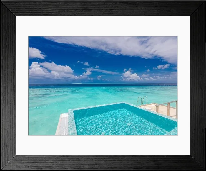 Framed Print : Infinity swimming pool with sea and ocean view on blue sky background. Luxury infinity pool over amazing turquoise lagoon and ladder into the water Framed Print : Infinity swimming pool with sea and ocean view on blue sky background. Luxury infinity pool over amazing turquoise lagoon and ladder into the water