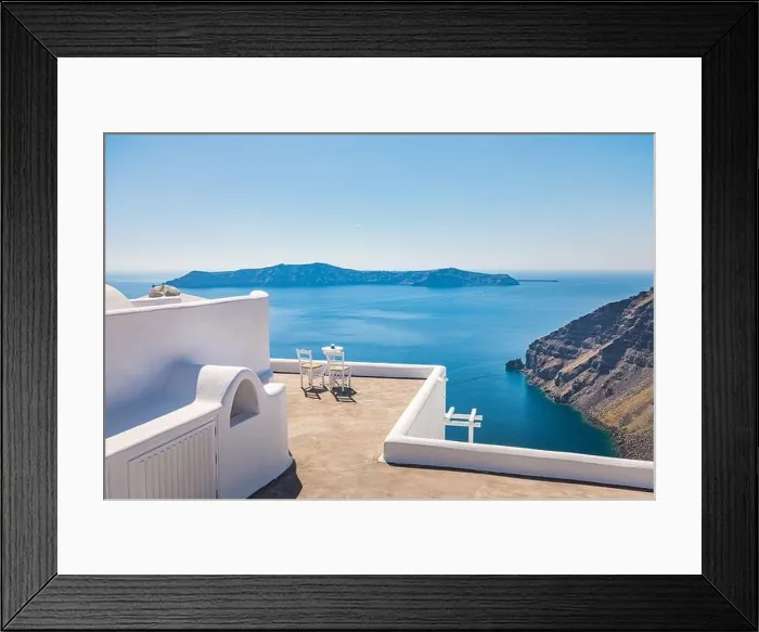 Framed Print : White architecture on Santorini island, Greece. Outdoor restaurant under a fantastic sunset landscape, chairs couple. Romantic view, summer vacation Framed Print : White architecture on Santorini island, Greece. Outdoor restaurant under a fantastic sunset landscape, chairs couple. Romantic view, summer vacation