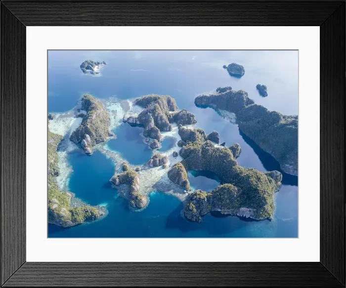 Framed Print : Beautiful limestone islands rise from Raja Ampat's seascape. This remote part of Indonesia is home to the greatest marine biodiversity on Earth Framed Print : Beautiful limestone islands rise from Raja Ampat's seascape. This remote part of Indonesia is home to the greatest marine biodiversity on Earth