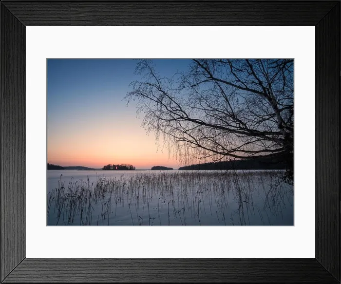 Framed Print : Scenic winter landscape with sunset and snowy lake at evening time in Finland Framed Print : Scenic winter landscape with sunset and snowy lake at evening time in Finland