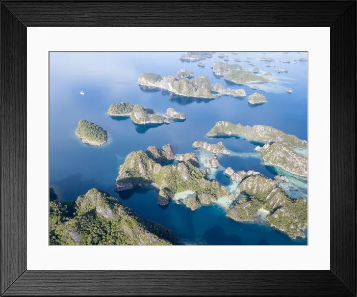 Framed Print : Beautiful limestone islands rise from Raja Ampat's seascape. This remote part of Indonesia is home to the greatest marine biodiversity on Earth Framed Print : Beautiful limestone islands rise from Raja Ampat's seascape. This remote part of Indonesia is home to the greatest marine biodiversity on Earth