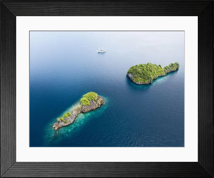 Framed Print : Beautiful limestone islands rise from Raja Ampat's seascape. This remote part of Indonesia is home to the greatest marine biodiversity on Earth Framed Print : Beautiful limestone islands rise from Raja Ampat's seascape. This remote part of Indonesia is home to the greatest marine biodiversity on Earth